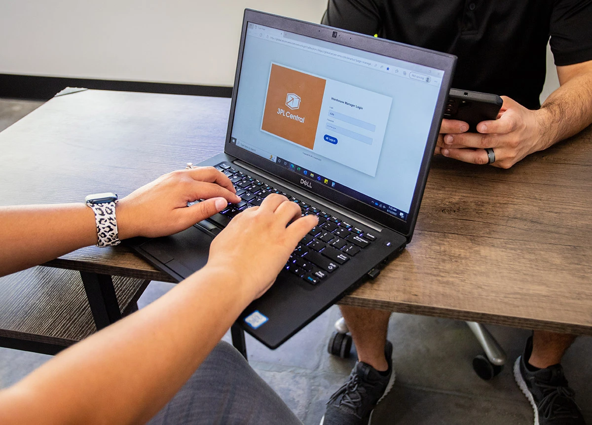 Innovative Technology Used by Freight Companies in Los Angeles - 3-WAY Woman logging in to warehouse management system on laptop