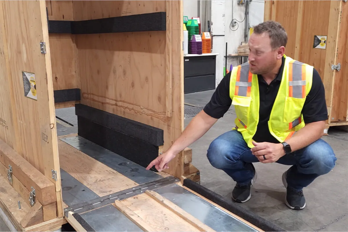 Machinery Moving in Dallas-Fort Worth: Tailored Rigging Solutions for Manufacturing & High Tech Equipment - 3-WAY A man looking over a packing crate