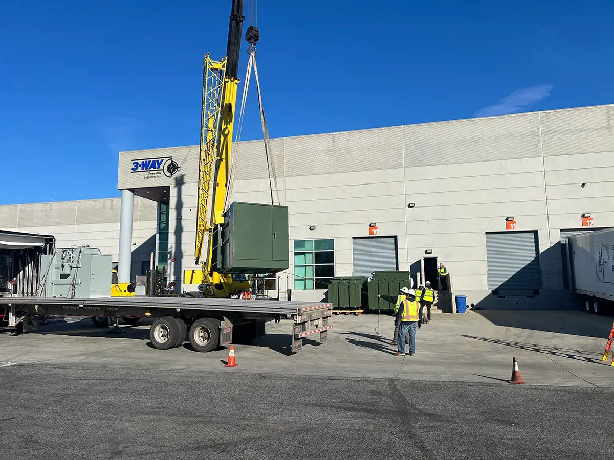 heavy-equipment-rigging The Three Way Logistics rigging division lifting heavy equipment with a crane