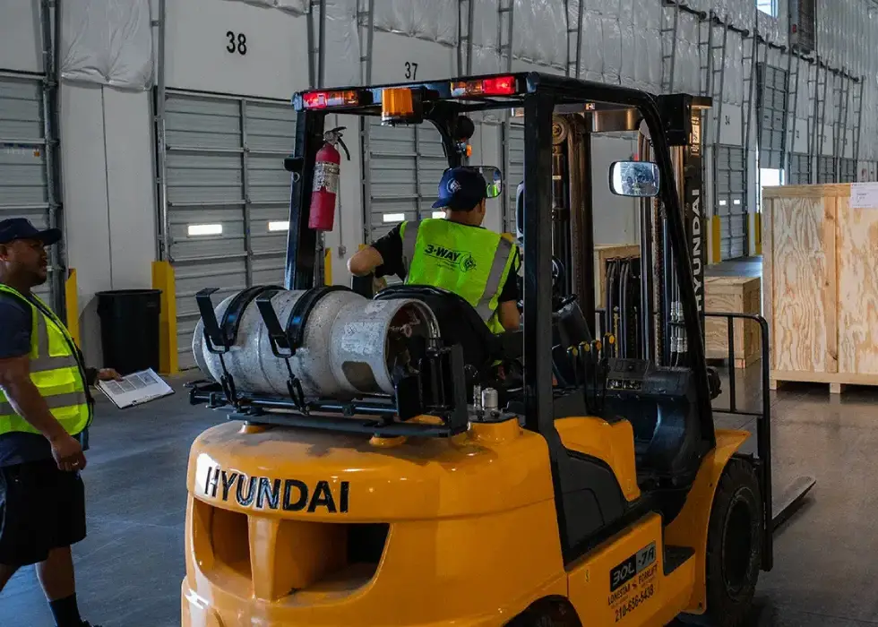 A man driving a forklift