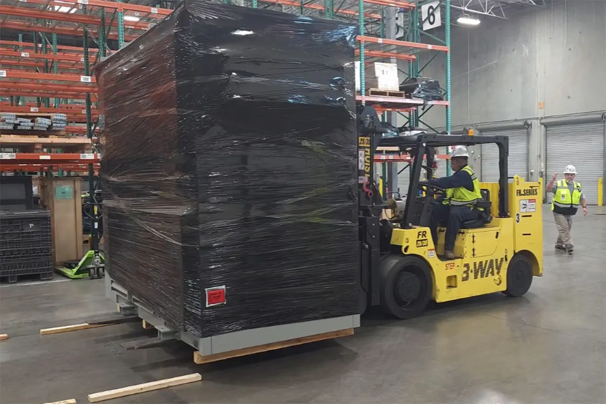 A forklift moving a data center